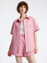 a lady in short sleeve pink shirt with pink shorts